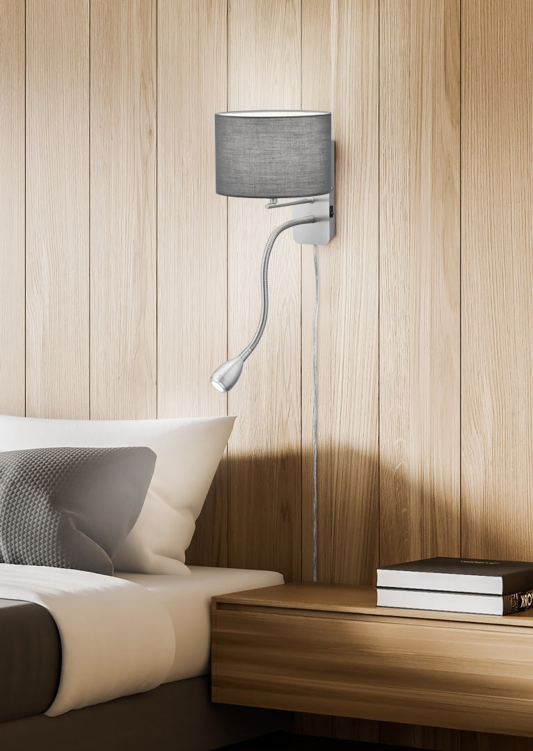 Modern wall lamp with a gray shade on a wooden wall above a sofa.