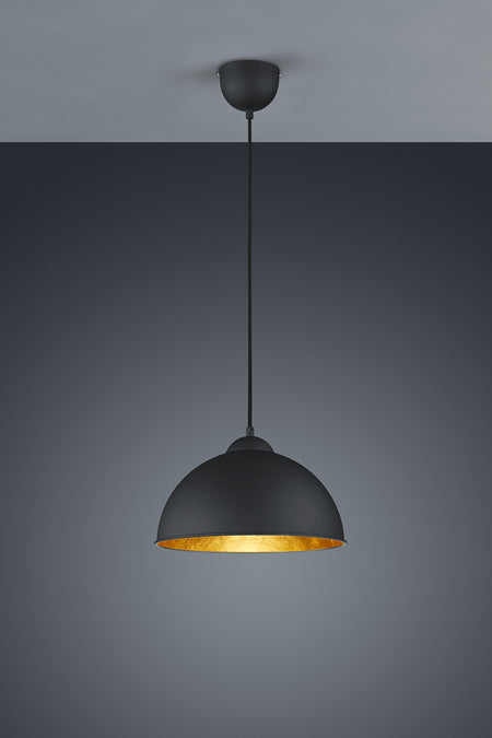 Black pendant light with gold interior on a gray background