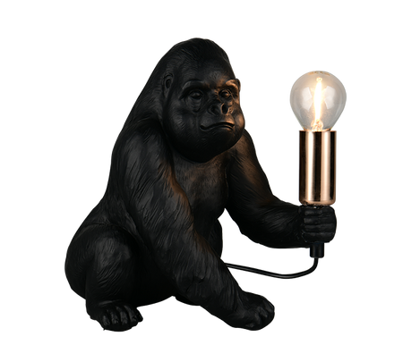 A gorilla-shaped table lamp with a black textured body, holding a glowing clear bulb in a metallic gold holder, shown on a plain white background.