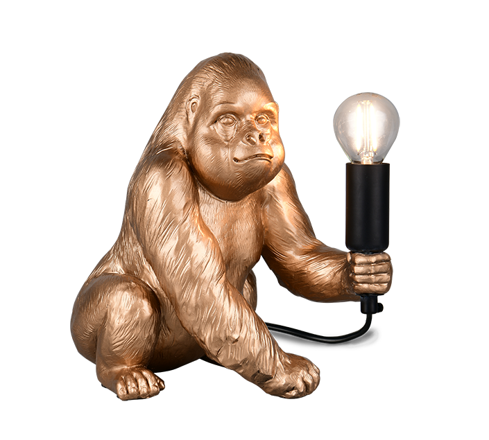 Gold gorilla lamp holding a light bulb on a white background