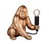 Gold gorilla lamp holding a light bulb on a white background