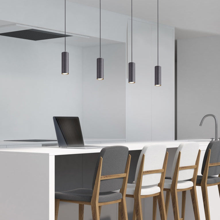 Modern kitchen with Marley pendant lights from Avanti Electrical, white countertops, and wooden chairs.