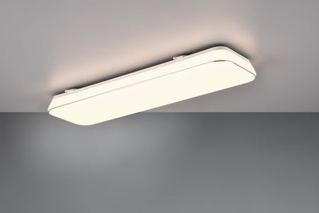 A white, rectangular LED ceiling light fixture mounted on a ceiling, emitting a warm white light.