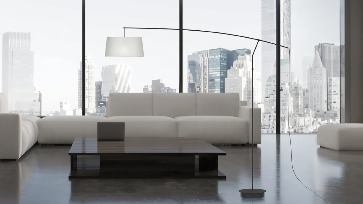 modern living room with a sofa and coffee table, featuring the Raisa Floor Lamp by Robin Lamps.