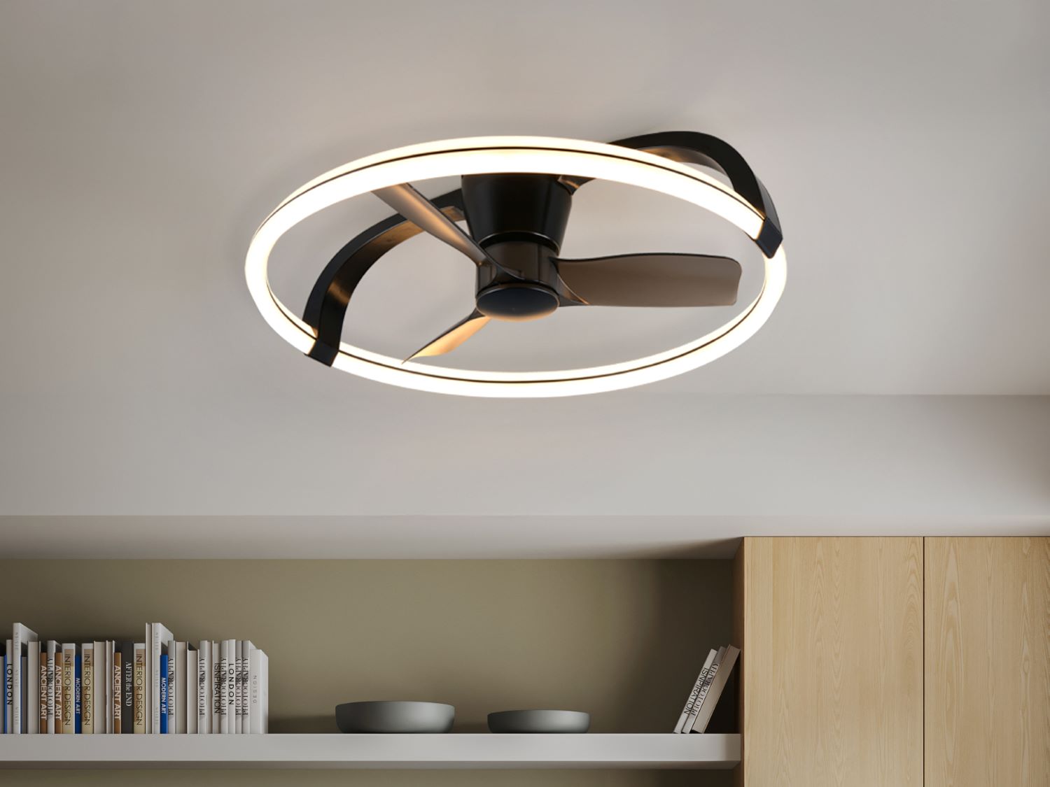 Ceiling fan with light fixture in a room with shelves and books.